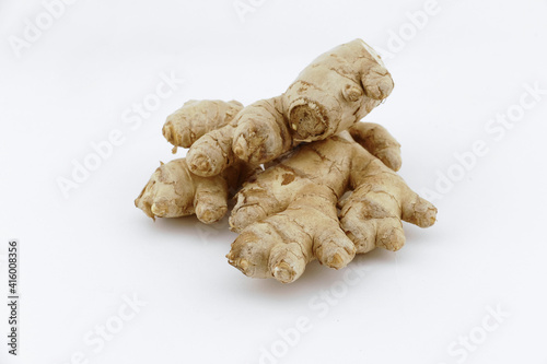 Fresh ginger on a white isolated background - close-up photo