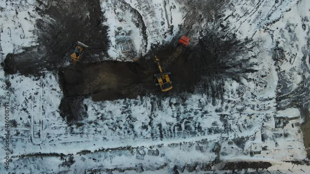 excavator digs the ground for building a house. aerial shooting from above excavator digs the ground for building a house. aerial shooting from above