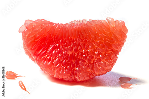 Fresh juicy piece of grapefruit pulp isolated on white background. Piece of peeled grapefruit close up. Slice of citrus fruit wallpaper