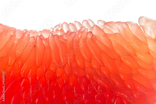 Fresh juicy grapefruit pulp background. Piece of red grapefruit macro close up. Citrus fruit texture wallpaper