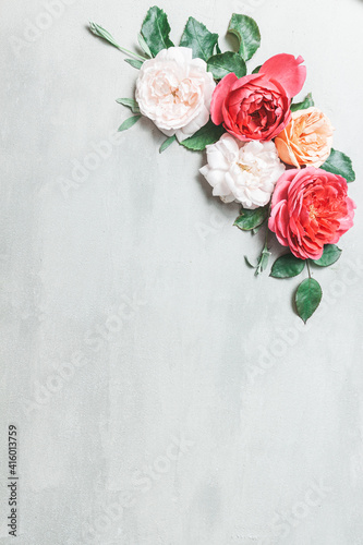 Composition from summer flowers. Rose flowers on pastel pink background.