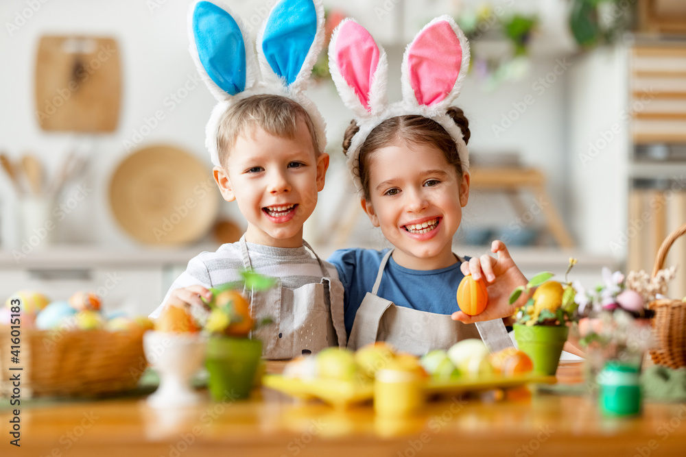 Fototapeta premium Happy easter! funny funny children with ears hare getting ready for holiday