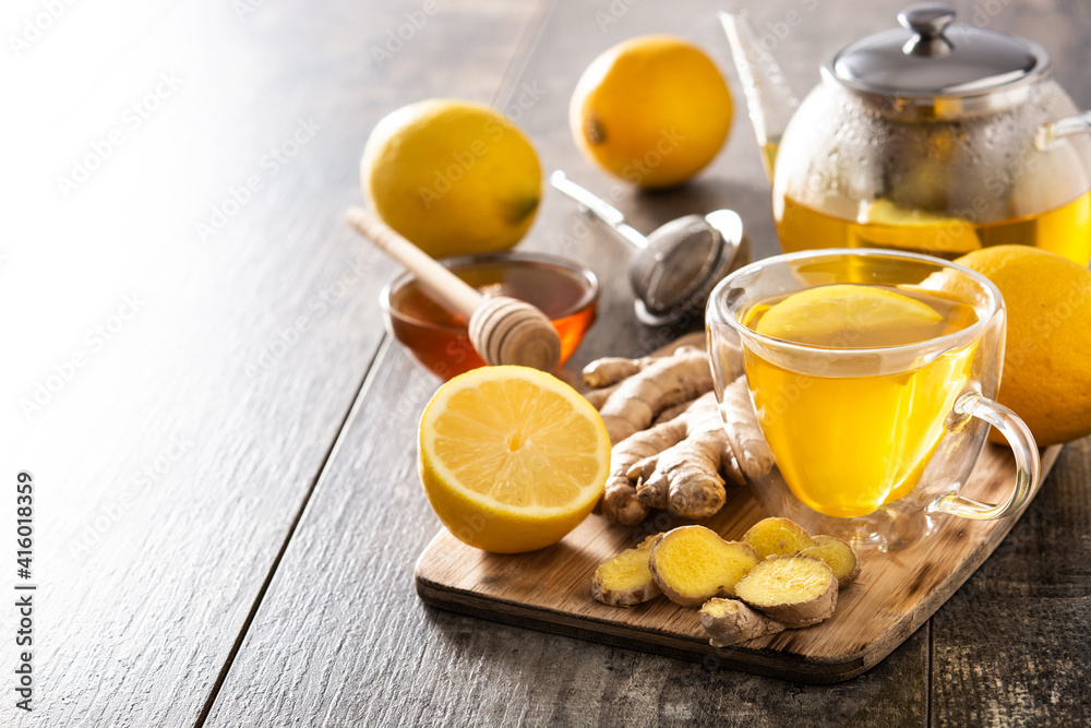 Ginger tea with lemon and honey in crystal glass on wooden table.Copy space Ginger tea with lemon and honey in crystal glass on wooden table.Copy space