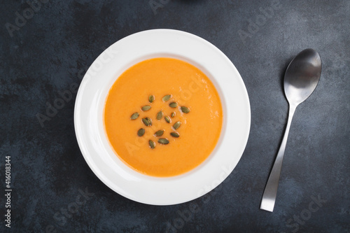 Autumn pumpkin cream soup with seeds is healthy organic vegetarian food