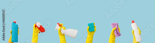 Hands in rubber gloves with cleaning supplies banner with free space for text