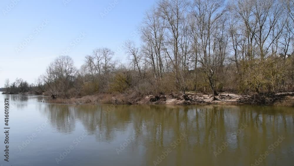 Winter landscape with Loire river, blue sky and trees Winter landscape with Loire river, blue sky and trees