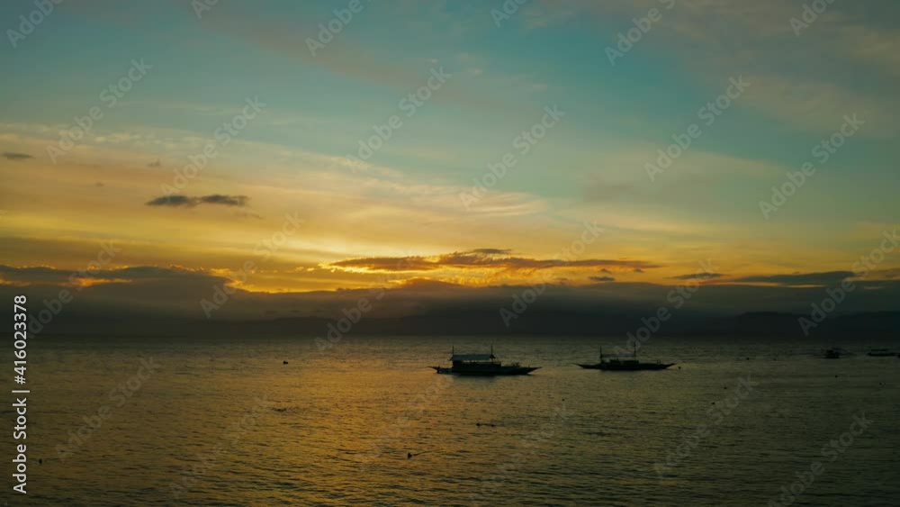 Colorful bright clouds during sunset over the sea, aerial view. Sunset over ocean. Seascape, Summer and travel vacation concept, Moalboal, Philippines. Colorful bright clouds during sunset over the sea, aerial view. Sunset over ocean. Seascape, Summer and travel vacation concept, Moalboal, Philippines.