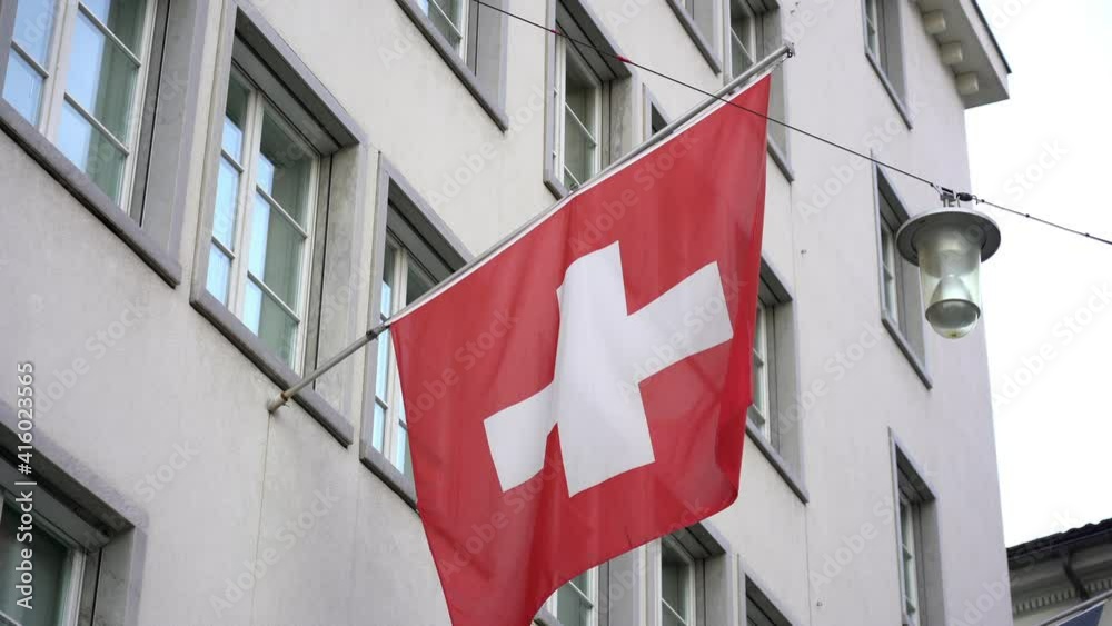 Swiss Coira march 2021 - flag of switzerland flutters in the wind