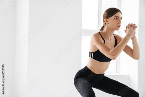 Athletic young sportswoman doing exercise while working out © Drobot Dean