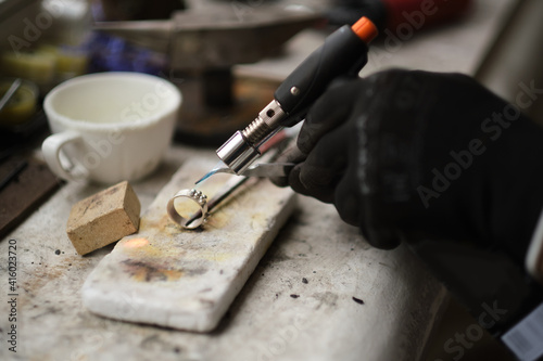 Craft jewelery making with professional tools. A handmade jeweler process, manufacture of jewellery. Melting metal
