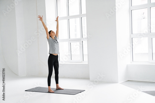 Athletic focused sportswoman doing exercise during yoga practice
