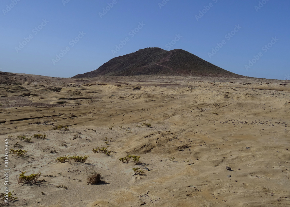 Eroded volcanic landscape in El Medano and the Red Mountain un the rear. South of Tenerife. Canary Islands. Spain.