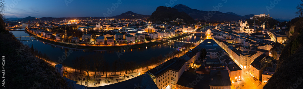 Panoramic view of historic city of Salzburg with river Salzach at night, Austria