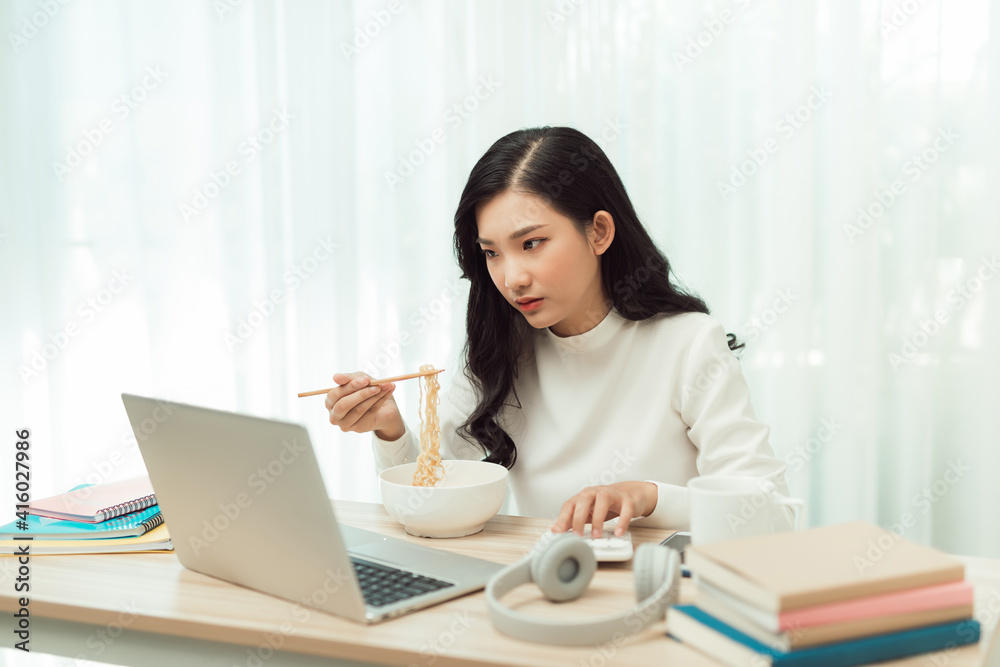 Young Asian girl sitting on desk work overtime, enjoy relax time.female working .