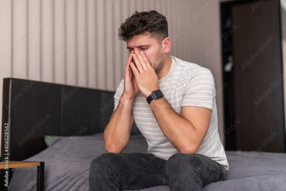 Handsome Man feeling bad lying in the bed and coughing Handsome Man feeling bad lying in the bed and coughing