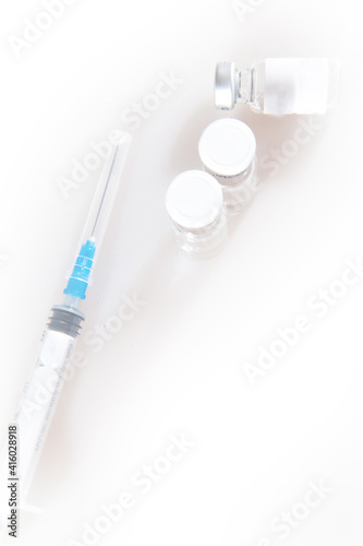 Medical syringe and three ampoules with antiviral vaccine