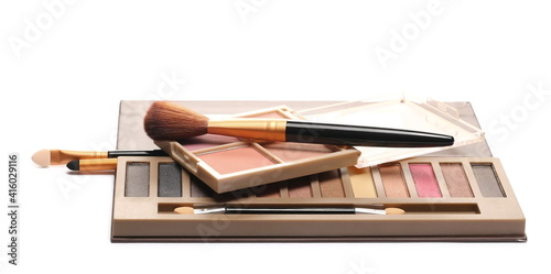 Eye shadow makeup palettes with mirror and cosmetic applicator brush set isolated on white background
