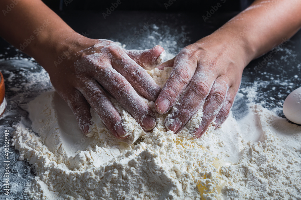 Cook hands preparing dough for homemade pastry.