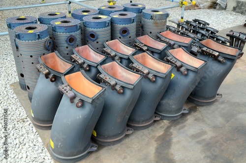 Gas turbine burner heads placed on the floor to wait for inspection.