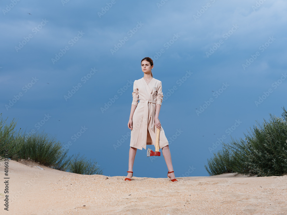 Woman sundress red shoes ax sand nature blue sky Woman sundress red shoes ax sand nature blue sky