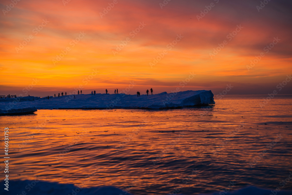 Blocks of ice on the seashore at sunset