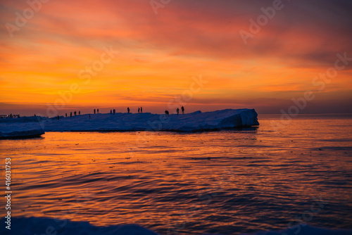 Blocks of ice on the seashore at sunset