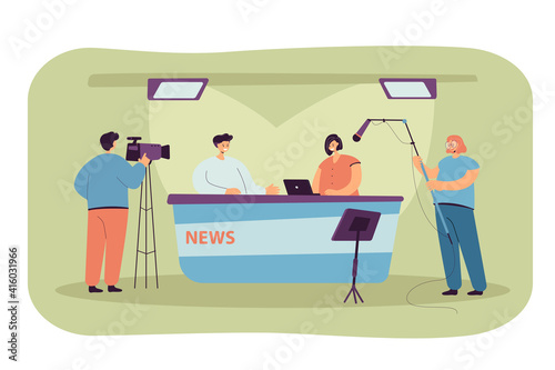 Two journalists sitting at desk on TV studio isolated flat vector illustration. Cartoon professional crew cameraman shooting interview show or news. Entertainment and backstage concept