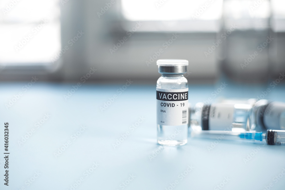 a jar of coronavirus vaccine. on a blue background. copy space, banner