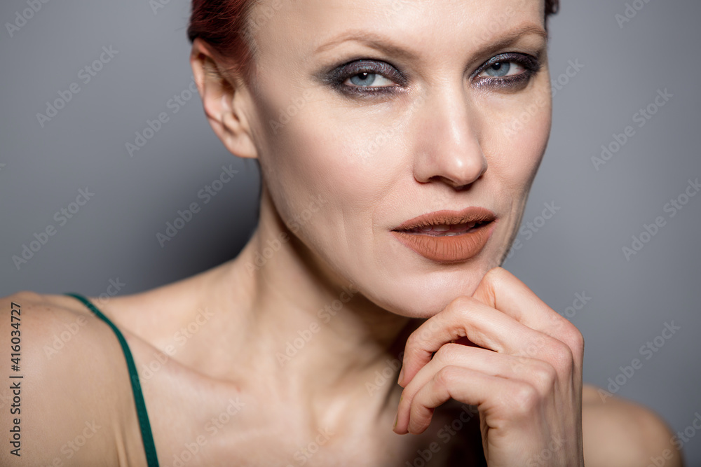 Very attractive young woman close up portrait. Beautiful female indoor. Red-haired girl. Redhead with short hair over grey background Very attractive young woman close up portrait. Beautiful female indoor. Red-haired girl. Redhead with short hair over grey background