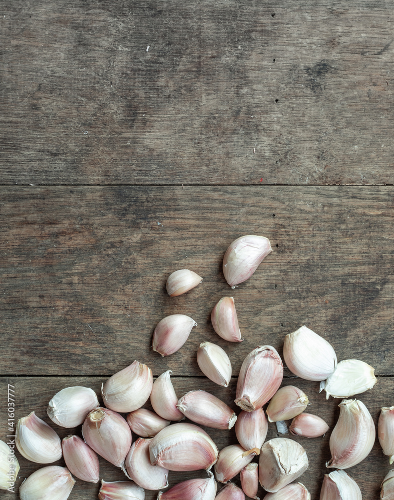 garlic, herb vegetable ingredient on Brown wood texture background