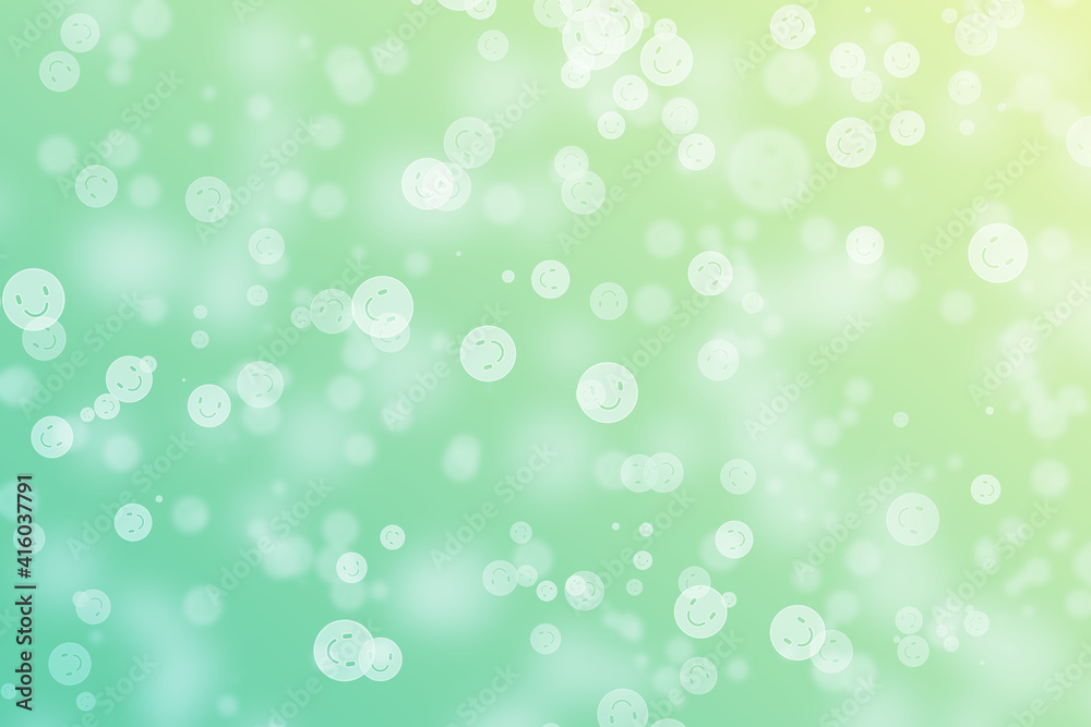 Bokeh background with circle happy face theme on green,yellow and gold coloured.