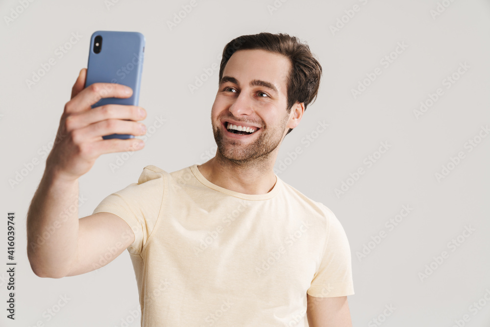 Happy handsome guy taking selfie photo on mobile phone Happy handsome guy taking selfie photo on mobile phone