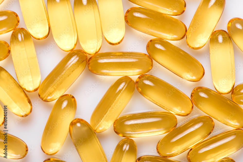 Heap of Omega 3 capsules on a white background. Top view, high resolution product. Fish fat. Heap of Omega 3 capsules on a white background. Top view, high resolution product. Fish fat.