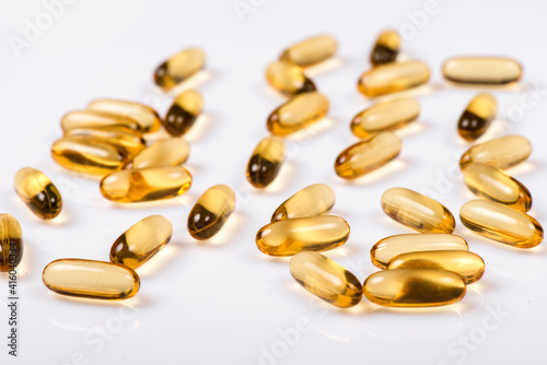 Heap of Omega 3 capsules on a white background. Top view, high resolution product. Fish fat.