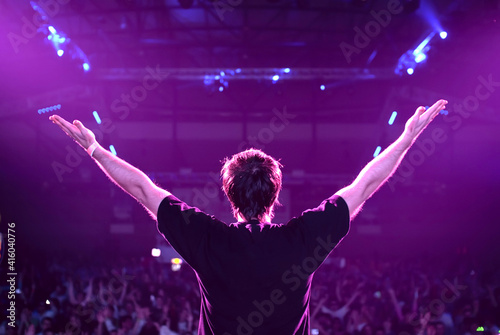 dj at the party stage with hands up