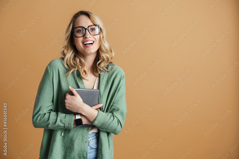 Happy beautiful woman in eyeglasses laughing while posing with calendar
