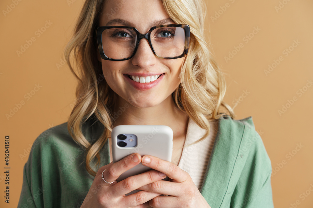 Happy beautiful woman smiling while using mobile phone Happy beautiful woman smiling while using mobile phone