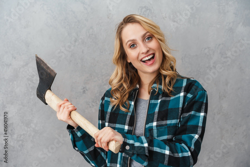 Happy beautiful woman smiling while posing with hatchet