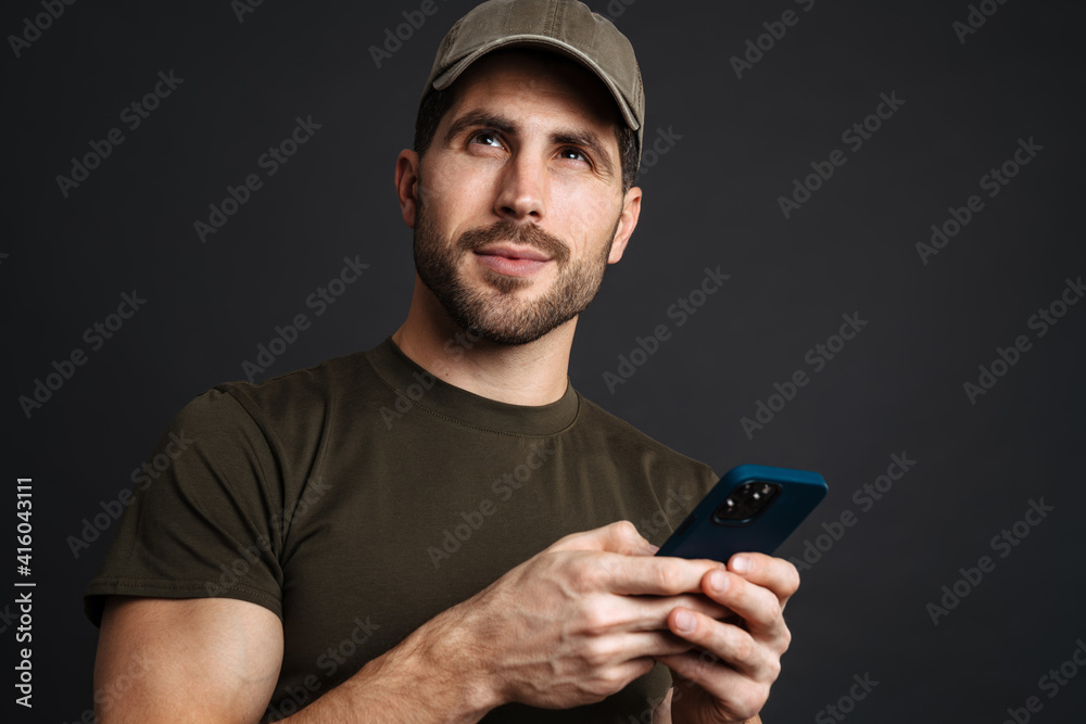 Confident young happy man holding mobile phone Confident young happy man holding mobile phone