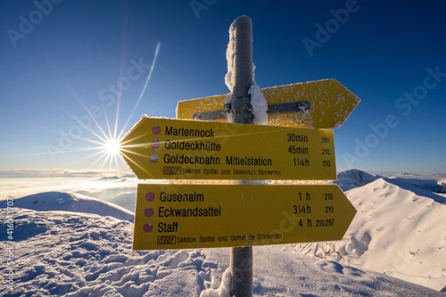 sunstar on the mountain with a route description photo