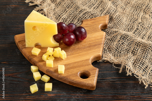 Cheese, grapes and nuts on a cutting board