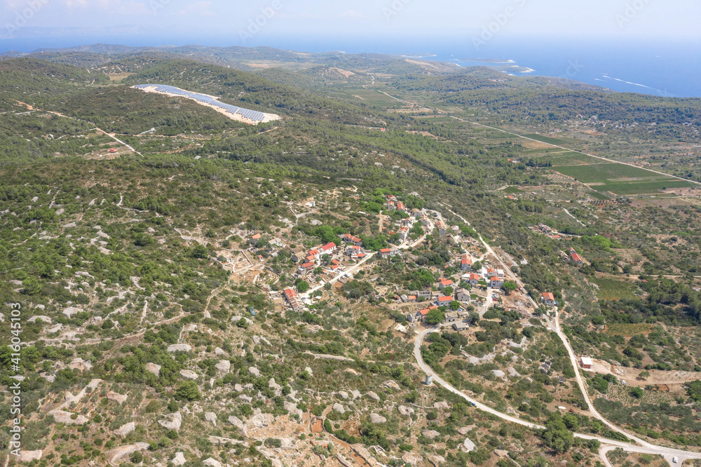 Aerial drone view of Zena Glava village near Tito's Cave on Vis Island with view of adriatic coastline