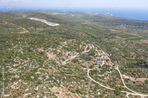 Aerial drone view of Zena Glava village near Tito's Cave on Vis Island with view of adriatic coastline