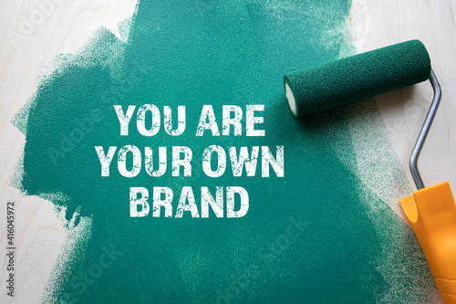 You Are Your Own Brand. Green painted wooden background