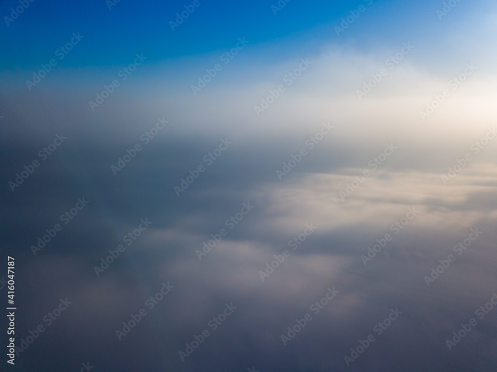 Flight high above the clouds. Aerial drone view.