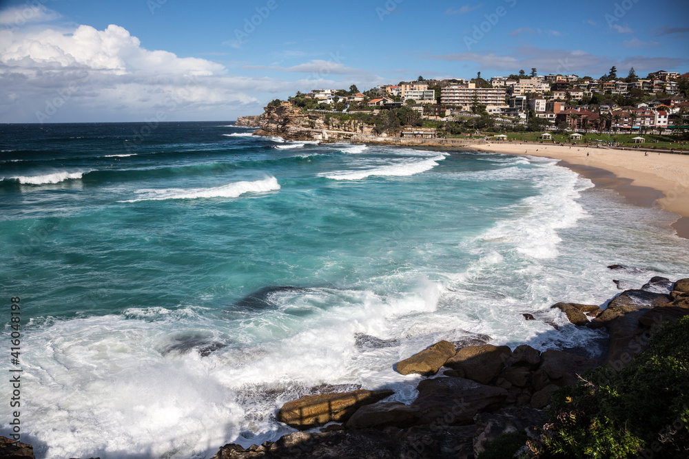 beach and sea with houses in the distance