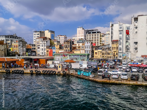 Istanbul, Turkey - October 29, 2019: Parking lot and buildings with graffiti on the walls on the Bosphorus waterfront in Istanbul. Modern cityscape on a sunny summer-autumn day