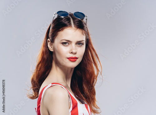 pretty red-haired woman striped dress and sunglasses fashion lips red