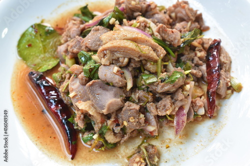 Thai spicy chop duck meat salad and fresh basil leaf with eggplant on plate