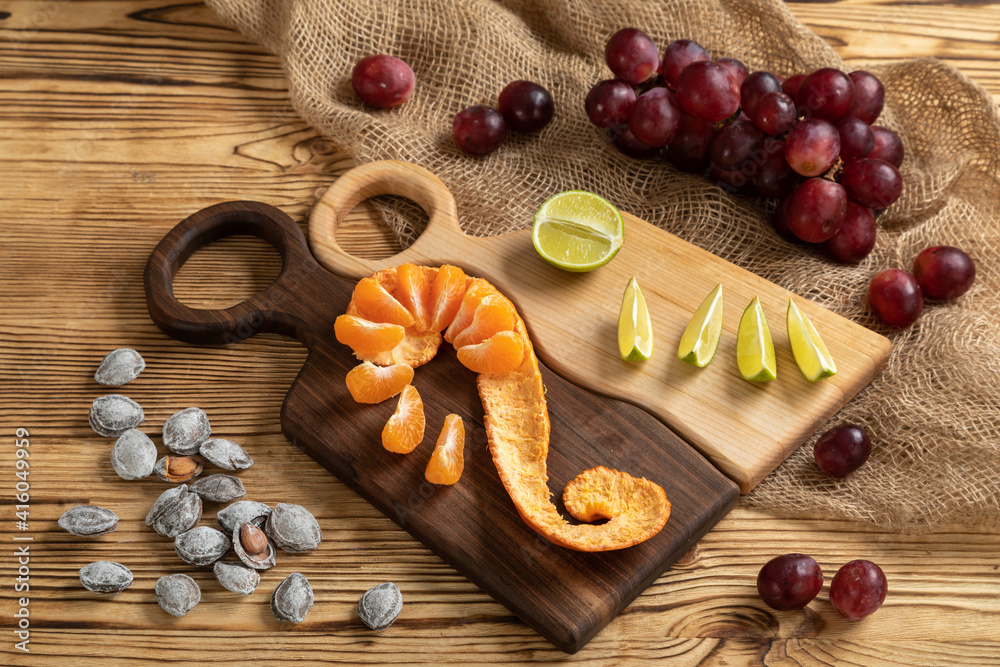 Cheese, grapes and nuts on a cutting board